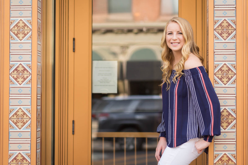 triway high school senior girl standing in door way of art find tile in downtown wooster ohio, colorful photo, photographed by Jamie Lynette Photography Canton Senior Photographer