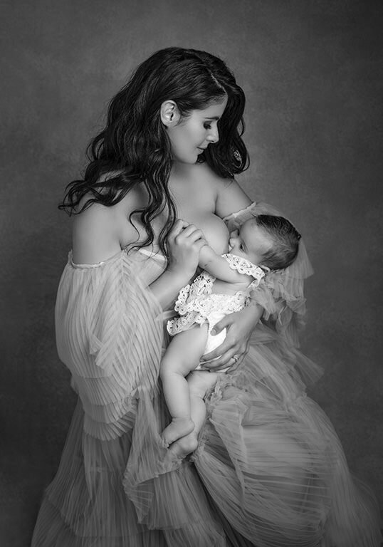 Stunning classic portrait of mother breastfeeding her baby. 