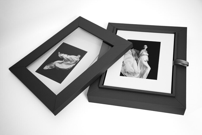 Opened reveal box with two maternity portraits visible