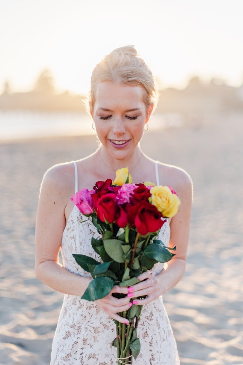 Woman on beach with colorful roses