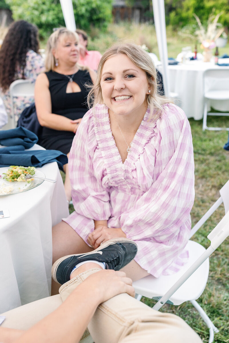 bay area photographers photographs wedding guest sitting at a table and chatting with other guests