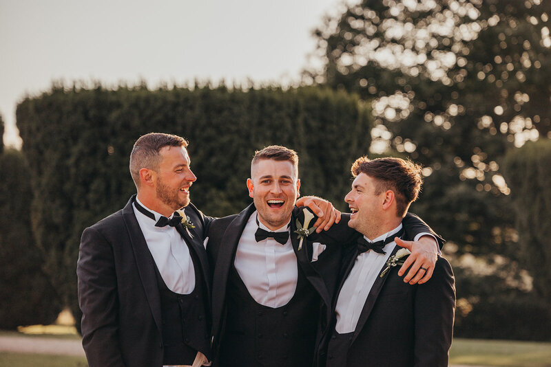 groom laughs with his best men