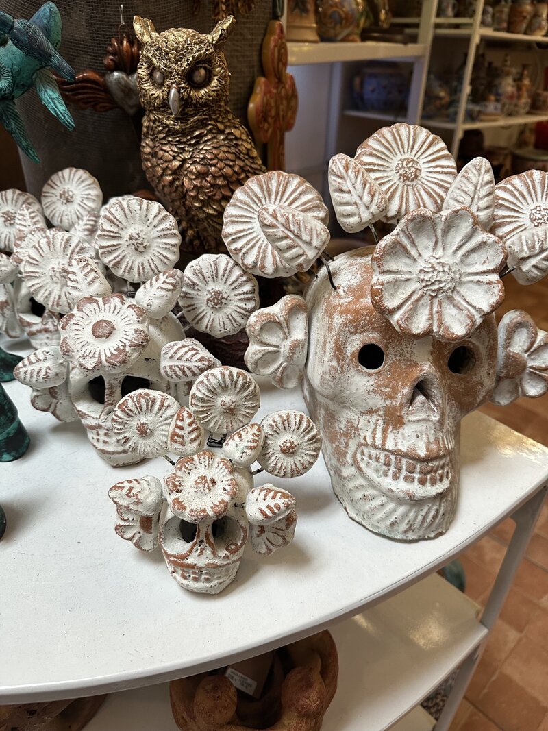 Mexican artisanal white wooden skulls on table 