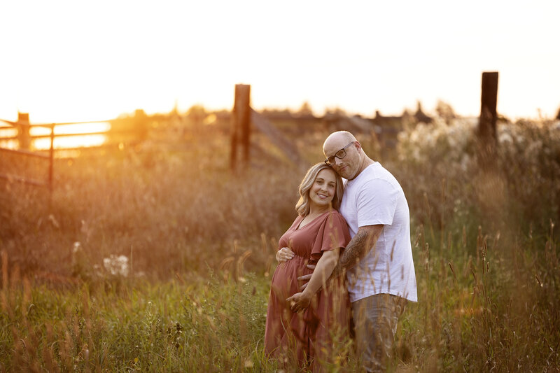 Mom and Dad embrace in maternity shoot