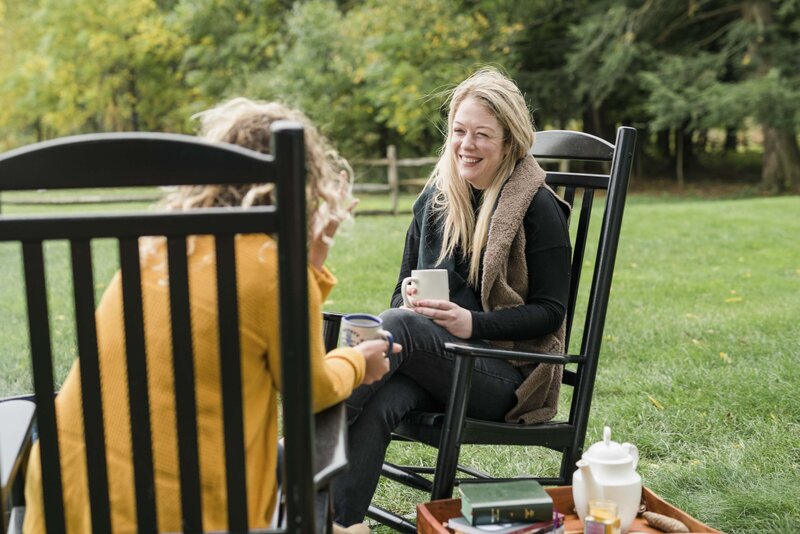 Amanda chatting with a woman over coffee