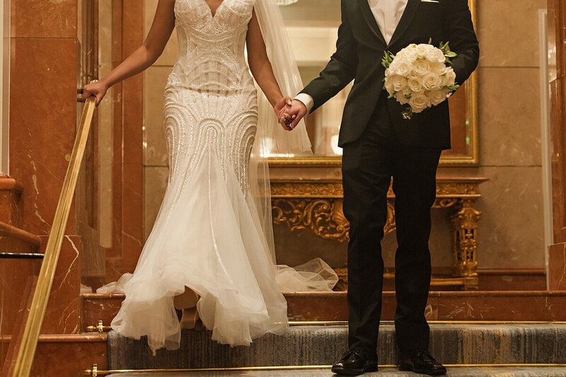 Couple walking down the steps of the  Four Seasons Atlanta