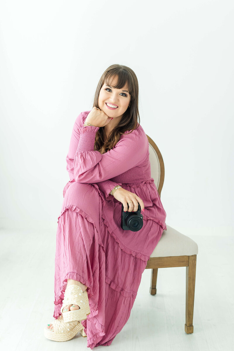 Josie Kitch holding camera smiling