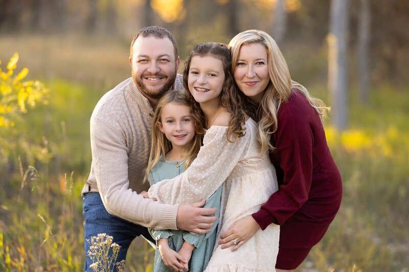 three family portraits hangin on a wall above a couch