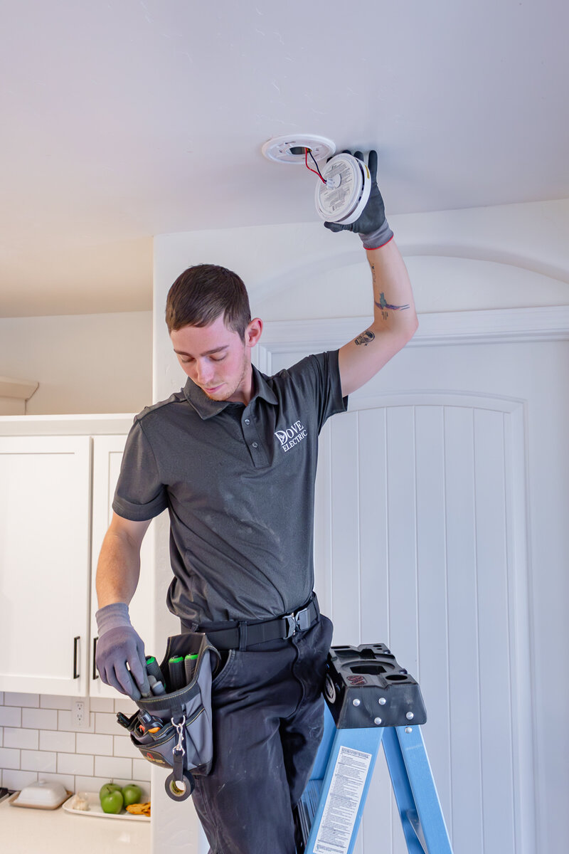 Dove Electric electrician in Albuquerque installing smoke alarm