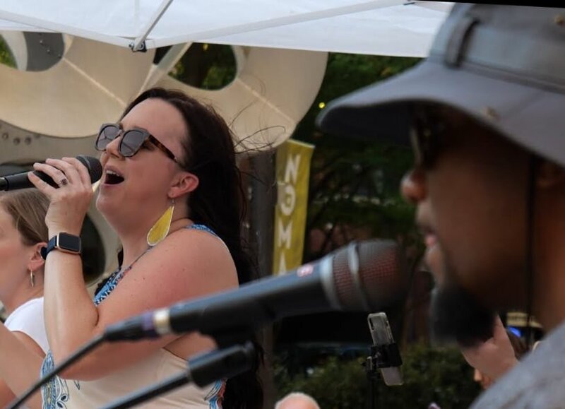 Two people singing on stage together 