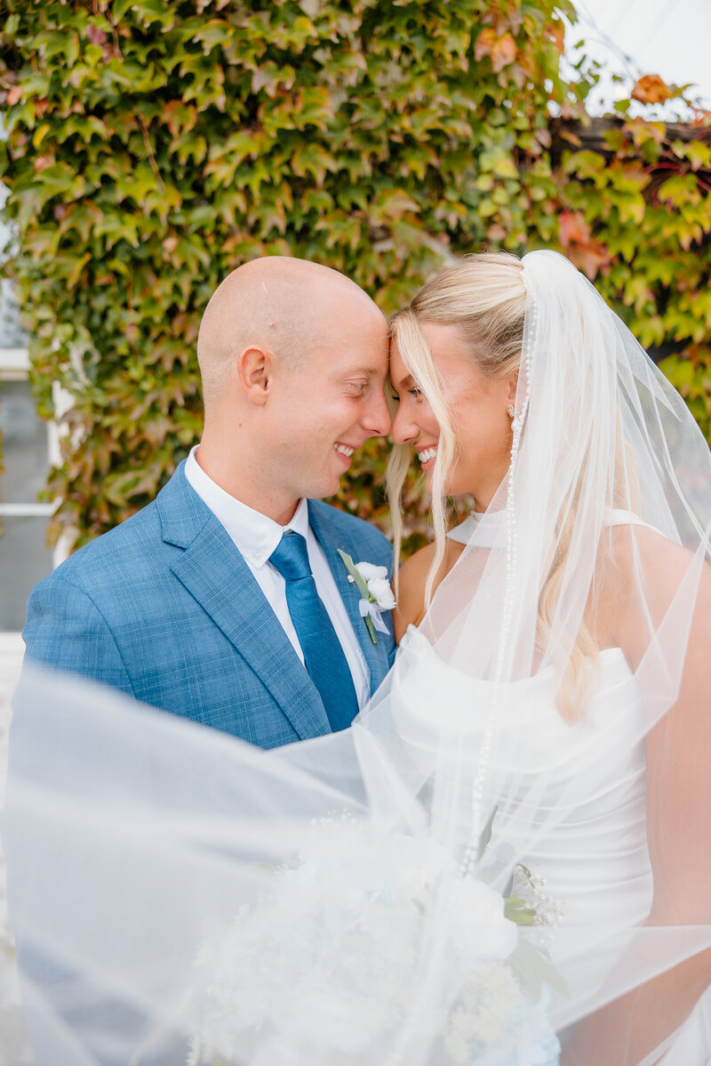 bridal portraits of bride and groom holding each other and smiling