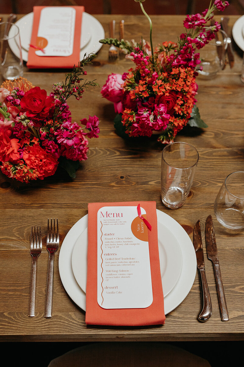 Small modern floral arrangements on long reception tables