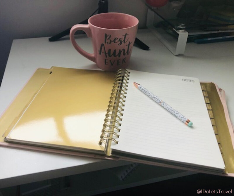 Working table that has notebooks and mug