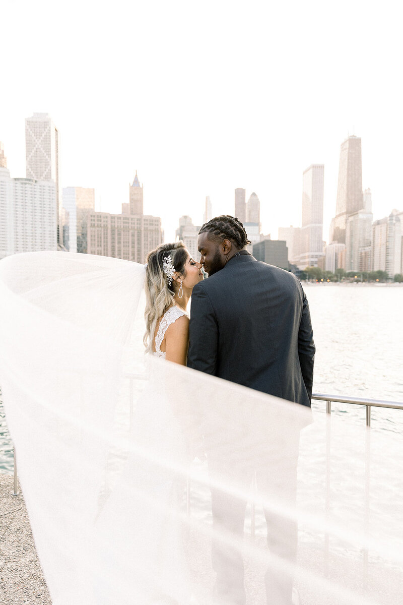 bride and groom nose to nose by chicago skyline