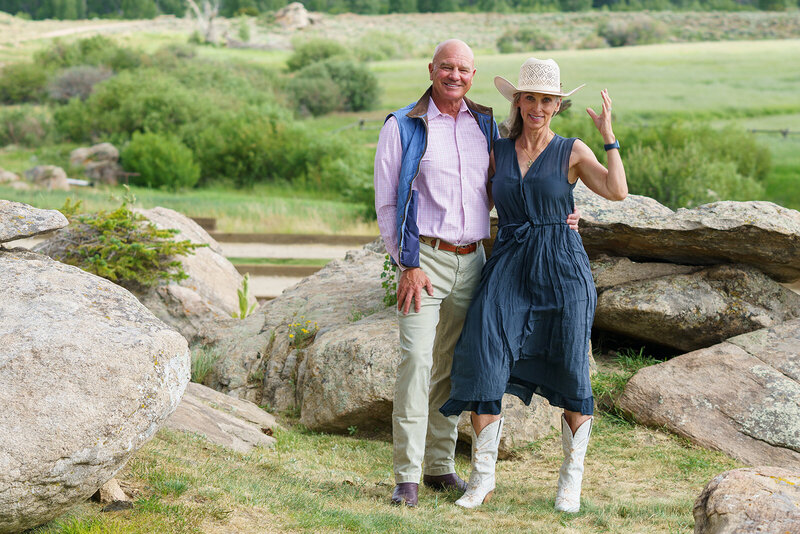 Chris posing with his wife, Linda, wearing a cowboy hat on a ranch in Wyoming