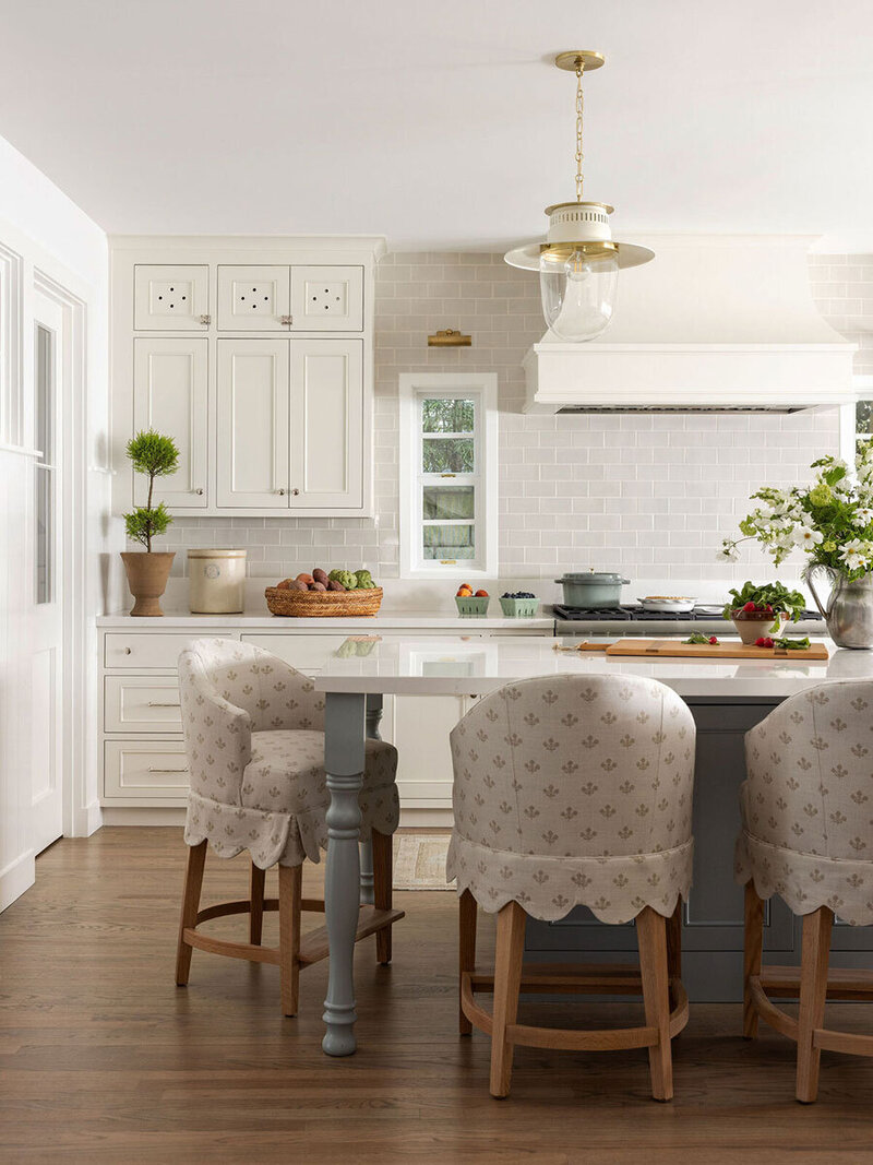 Custom kitchen with marble countertops and warm, classic cottage finishes
