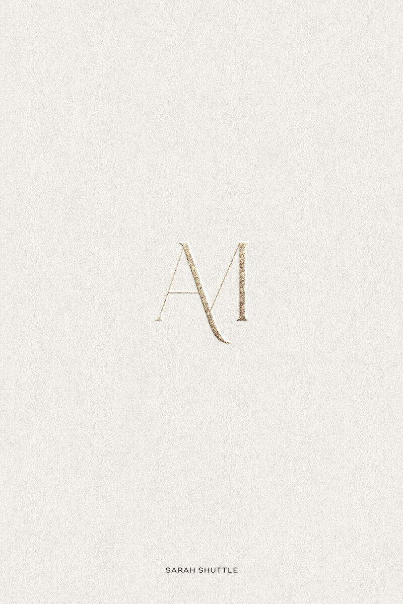 Gold foil HM monogram on textured cream paper for Anne-Marie Designs branding