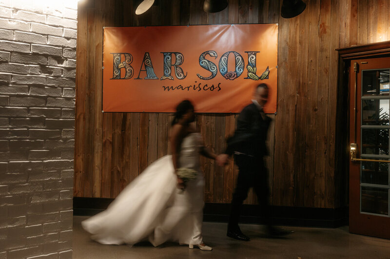 bride and groom going through bridal party tunnel