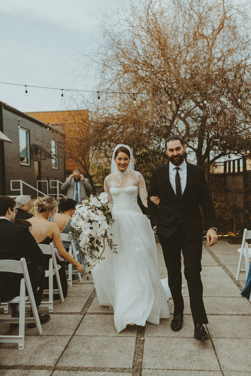 bride and groom posing on stairs