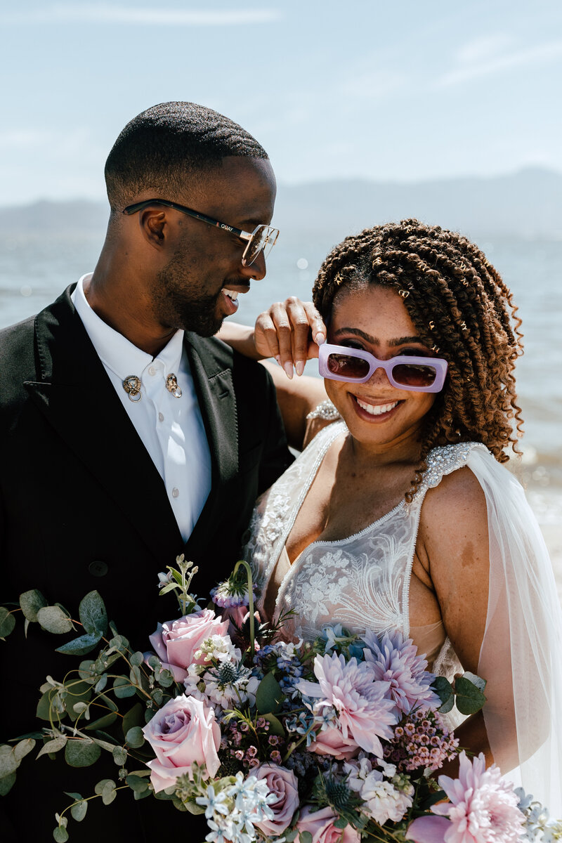 bride and groom smiling with sunglasses on