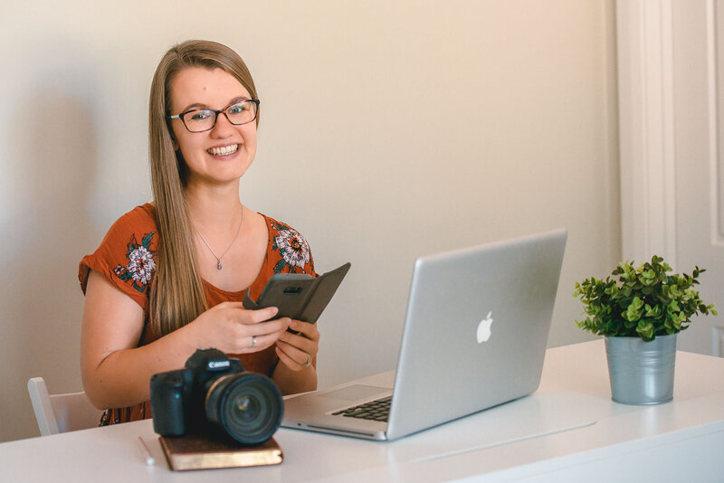 Brand photography with Virginia Beach photographers capturing small business owner working on her phone at a coffee shop
