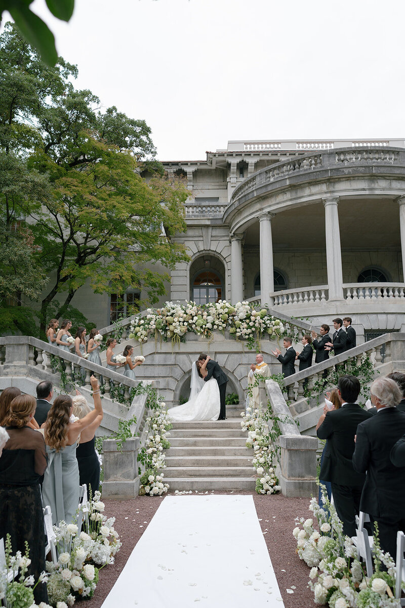 Kaitlyn and Chris at the ceremony on the stone staircase of Elkins Estate