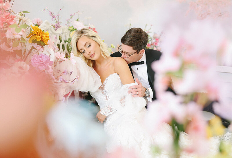 Bride and groom surrounded by flowers