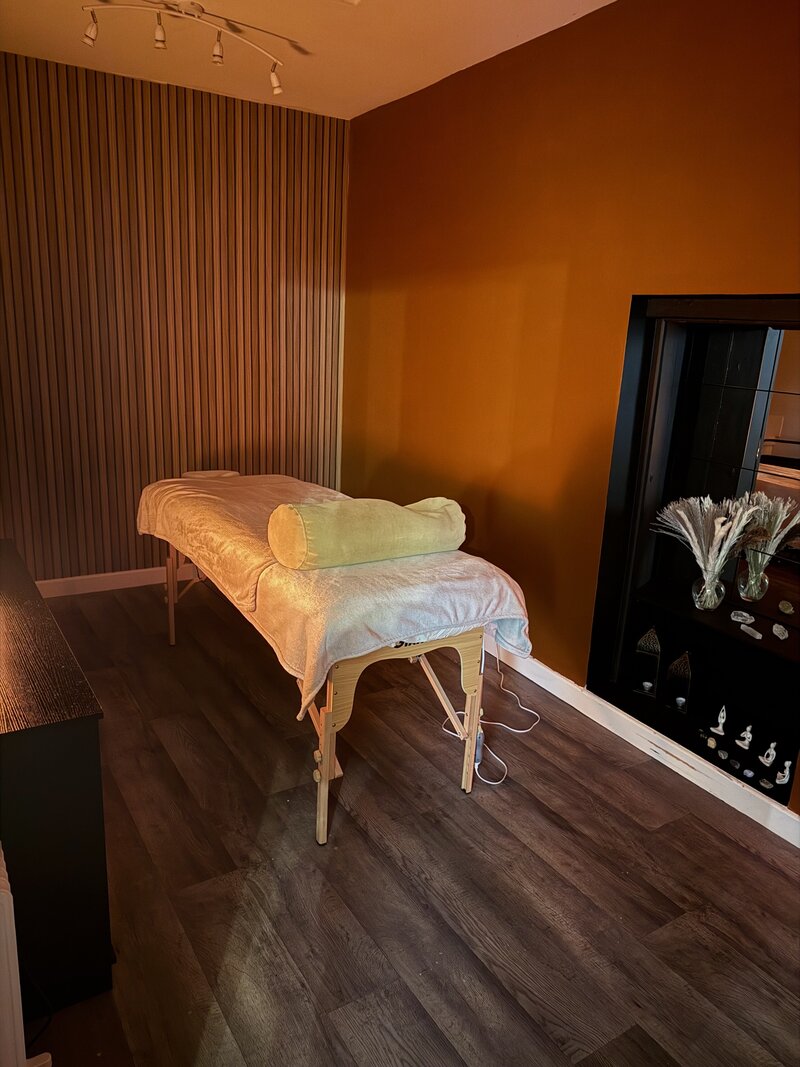 Image of a Nat Winterson of Studio Eight yoga studio n Wells, Somerset practising breathwork with hands on body