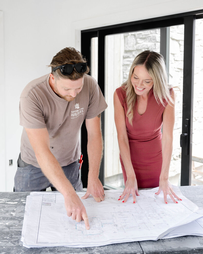 Client meeting reviewing custom home blueprints