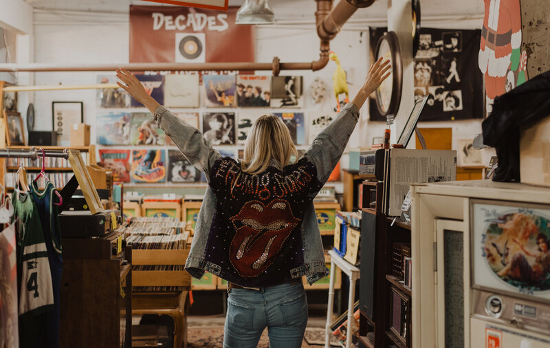 A woman poses for a photo in a record store.