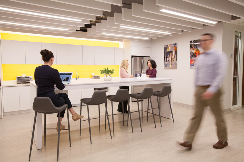 Corporate workspace with figure walking through it