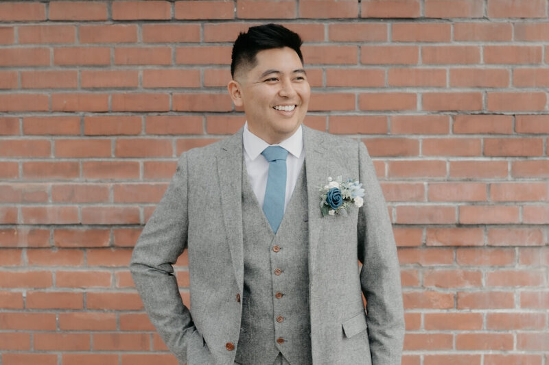 Wedding day videographer dressed in a stylish suit at The Junior League in Bakersfield, California.