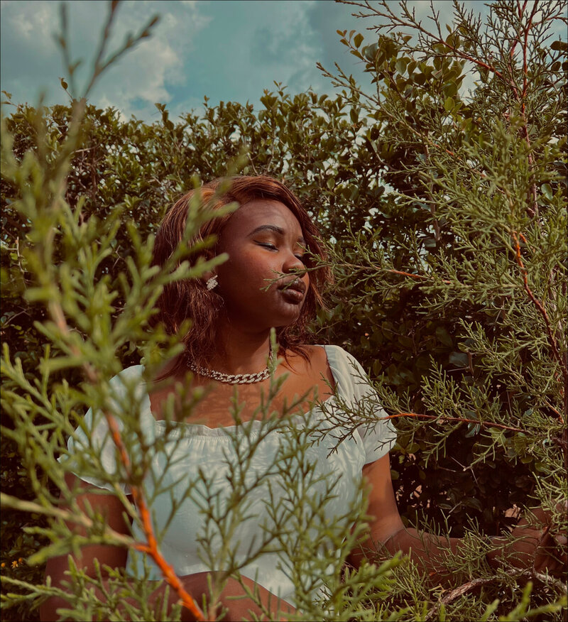 woman in trees looking off into the distance
