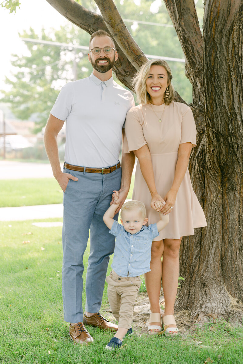 Cali Warner with Husband and son family photo in front of tree
