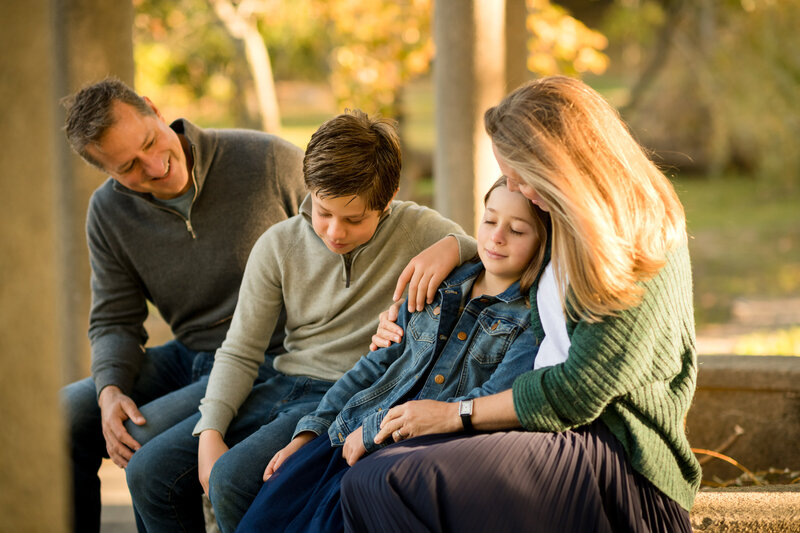 family embracing at Larz Anderson park