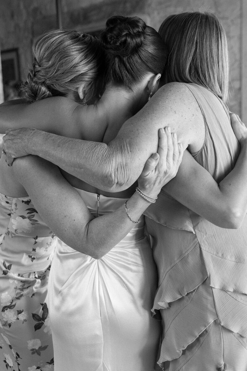 group hug between bride, mother of bride, and grandmother