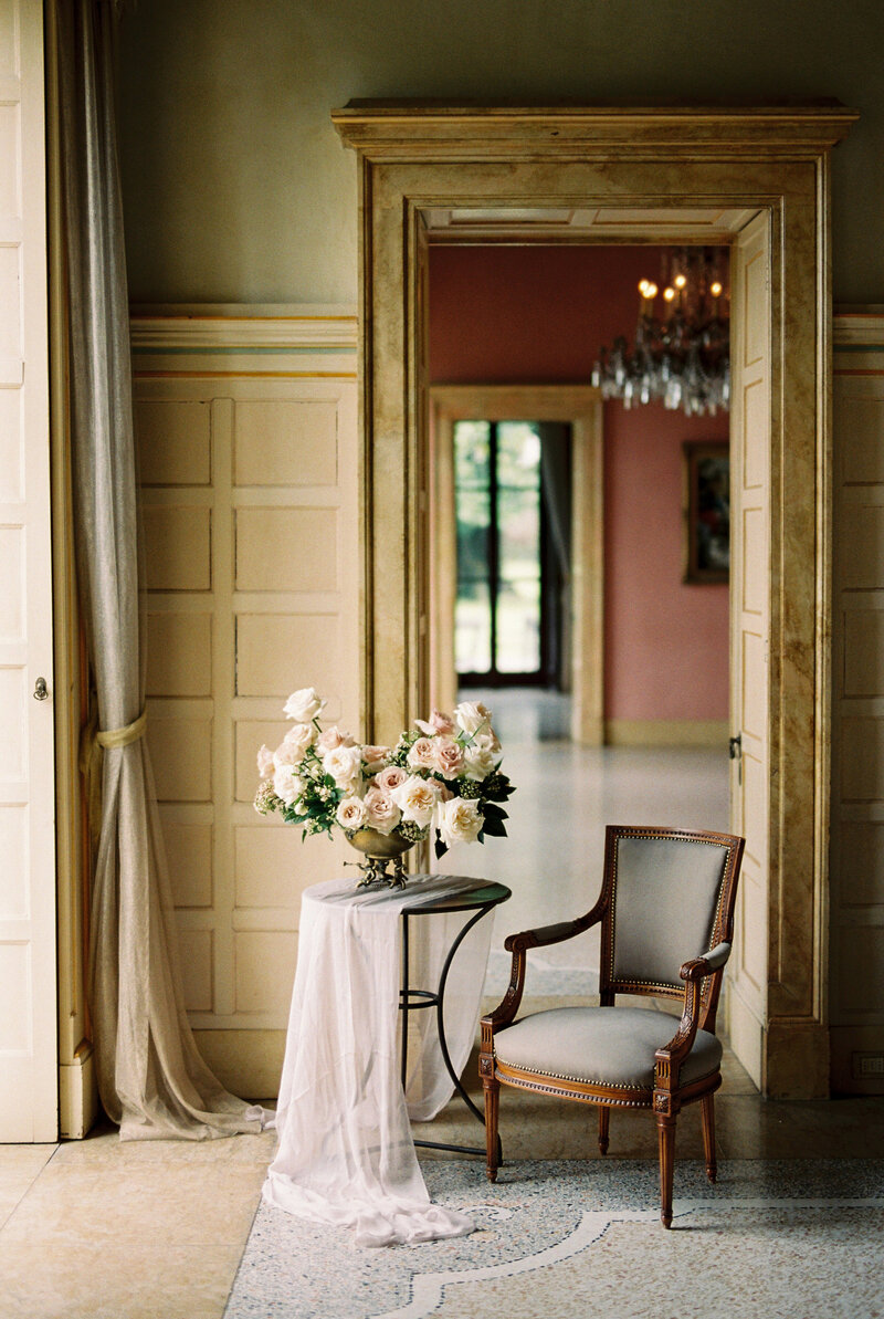 Elegant floral arrangement on table in vintage interior setting, styled for a wedding by Toronto wedding photographer