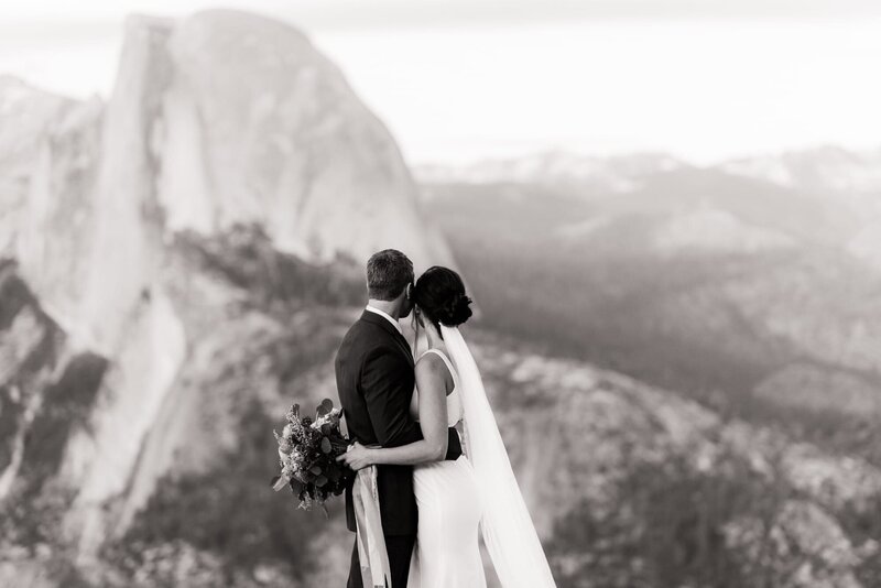 Bride and groom looking at Half Dome in Yosemite at a destination wedding