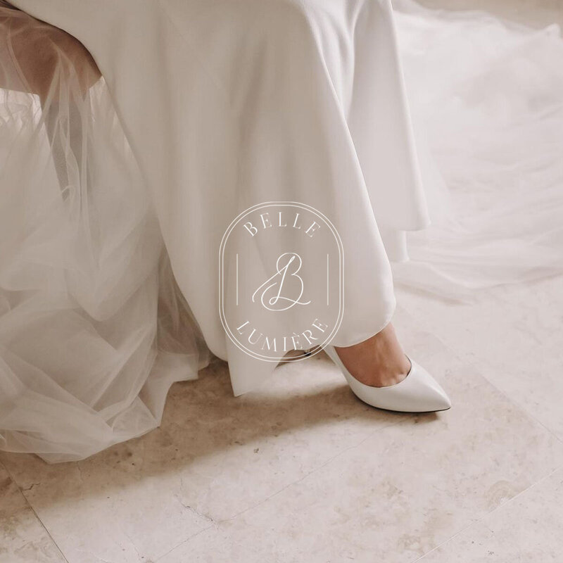 Neutral-toned shoe photograph with Belle Lumière Photography logo overlaid — part of her editorial brand identity