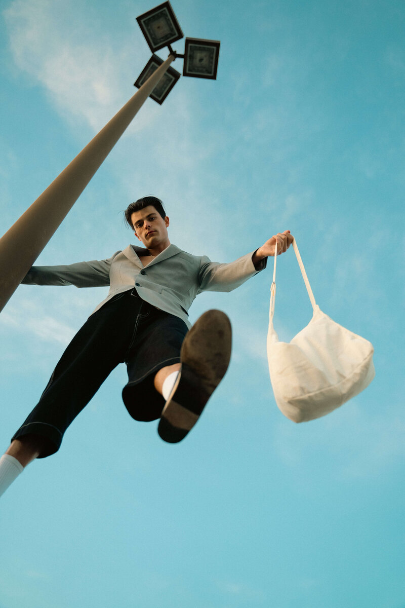 Editorial image of man modeling with bag