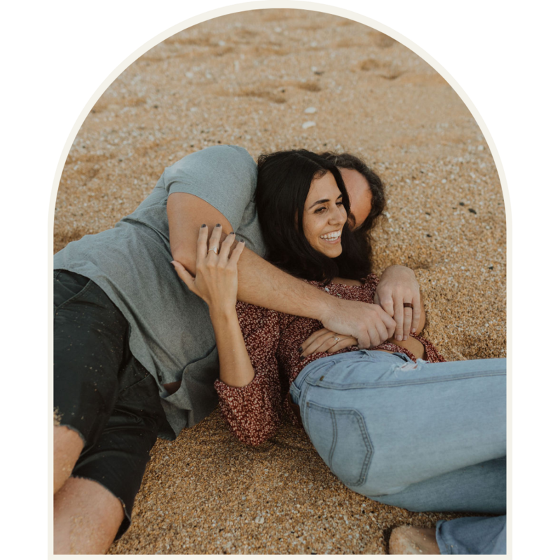 Couple laying together on the beach