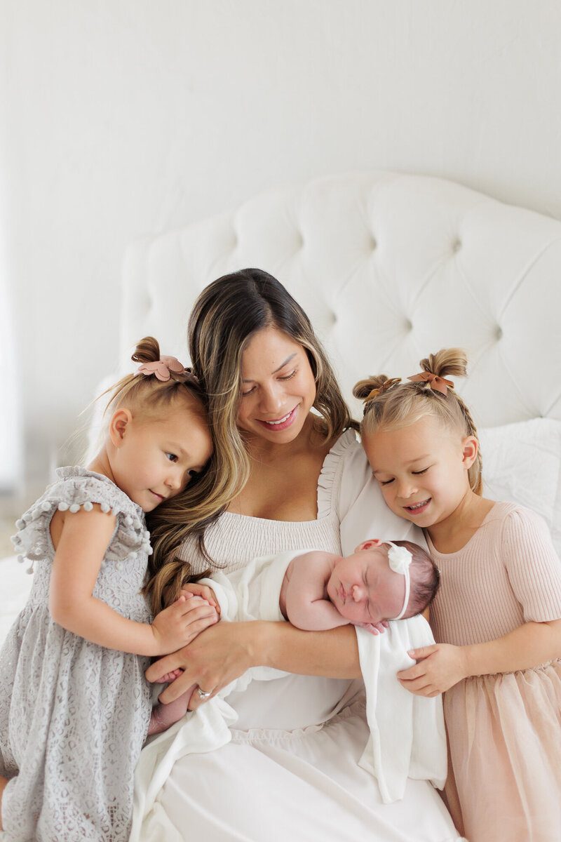 Mom and her 3 daughters in the Boise portrait studio of Tiffany Hix during newborn photography session.