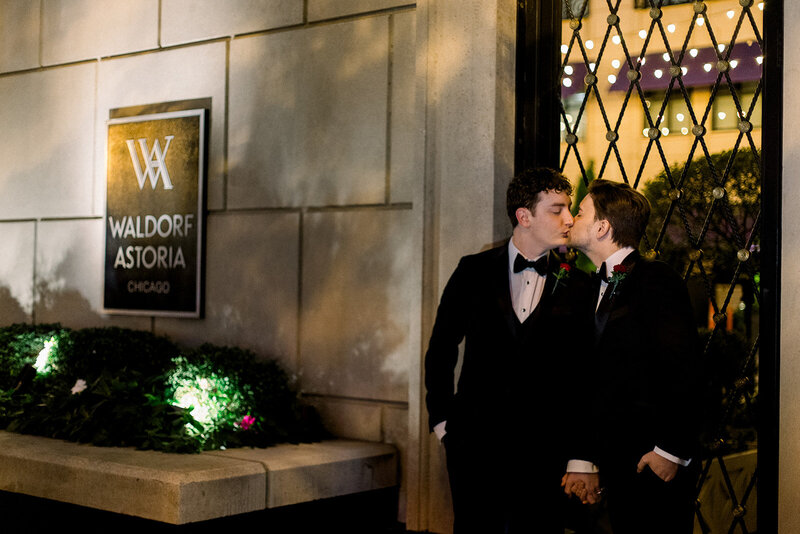 two grooms kissing at night