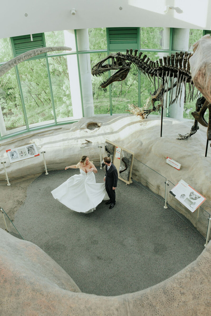 Couple dancing under dinosaur skeleton
