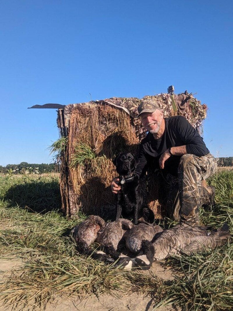 Customer with duck hunting dog