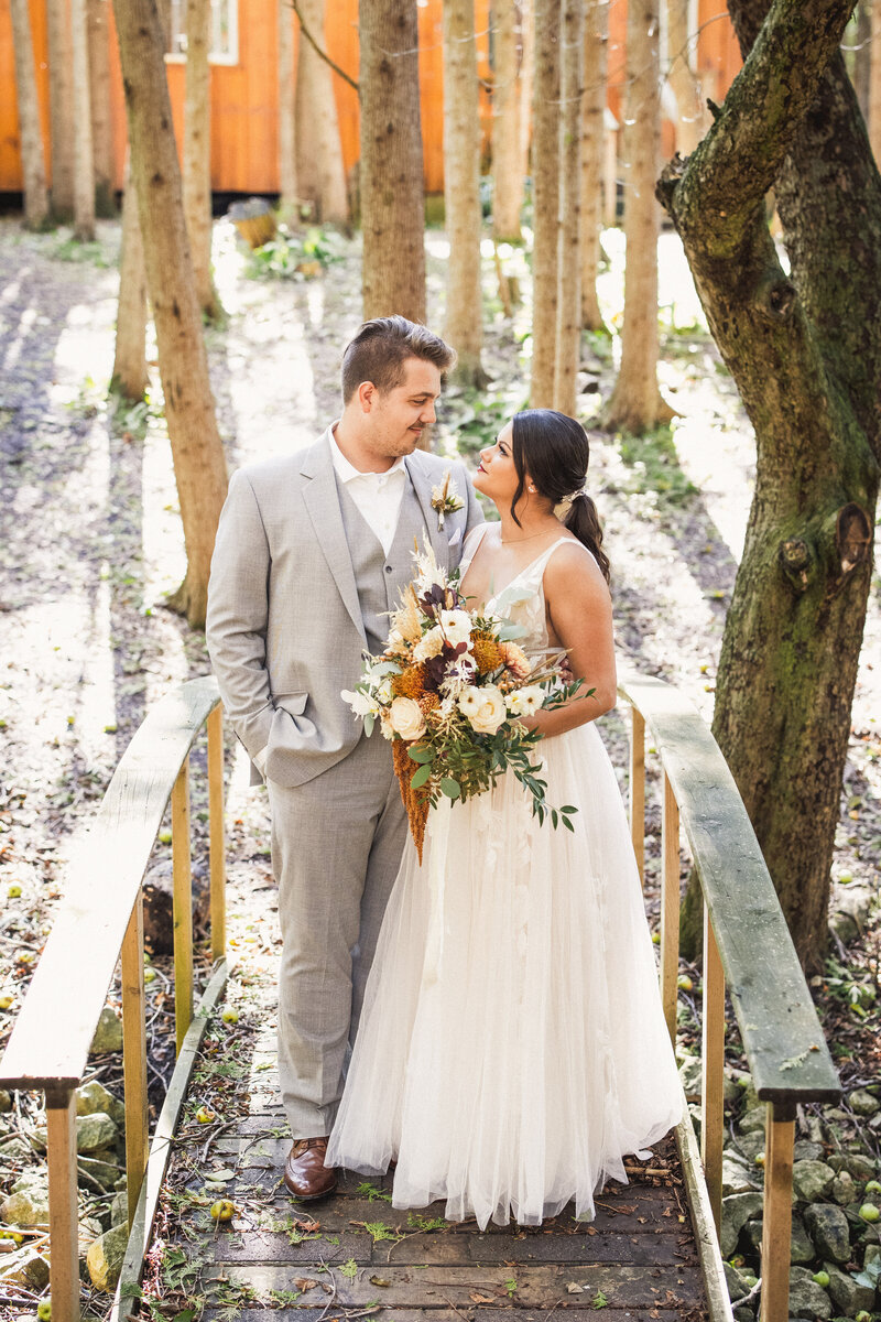 bride and bride and groom photos on  bridge at camp kintail