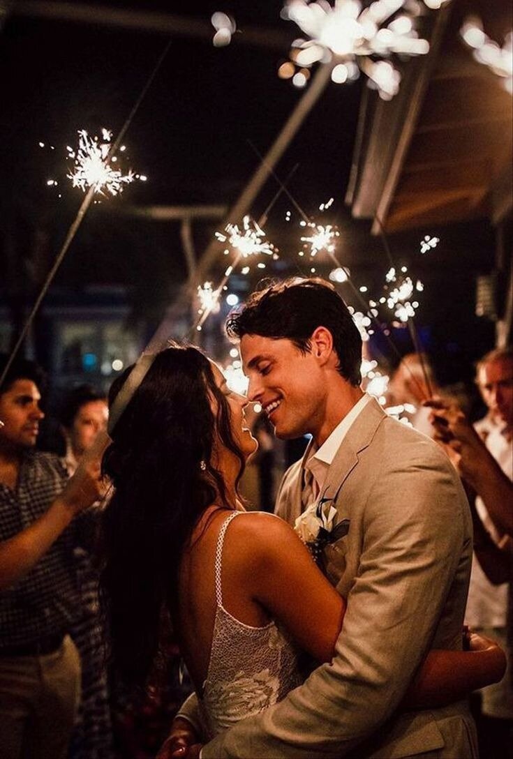 Groom with bride holding a bouquet