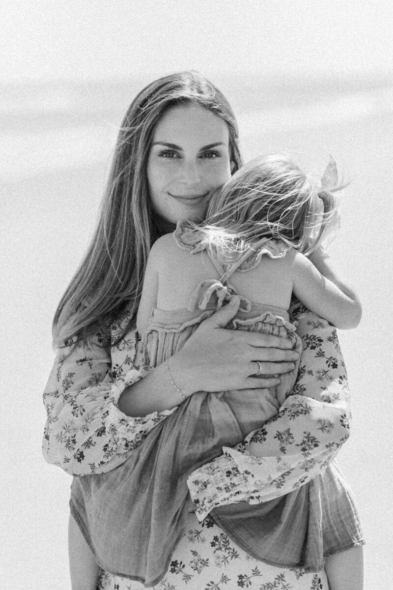 mama holding baby at the beach by Orlando lifestyle photographer
