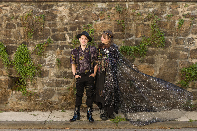 Bride and groom dressed in all black for a spooky-themed wedding in Phoenixville, showcasing their unique style.