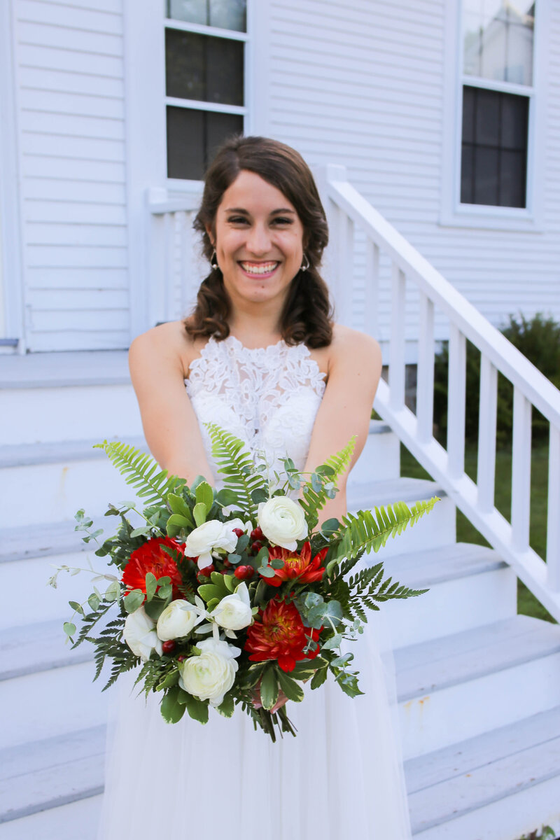 Bride holding out bouquet | Bar Harbor Wedding